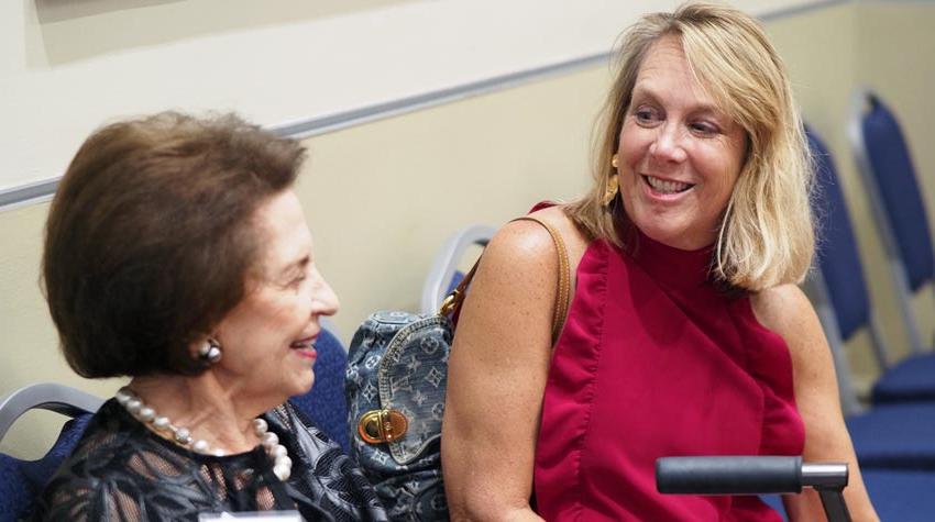 First Lady smiling at Arlene Mitchell.